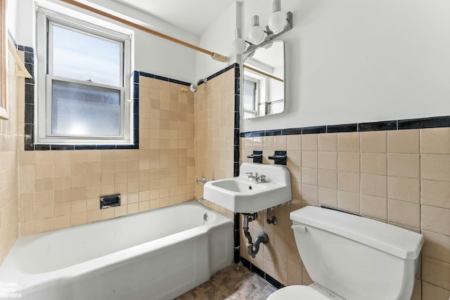 500 Grand St Unit C11A, New York City, NY 10002 - full bath with toilet, tile walls, bathing tub / shower combination, wainscoting, and a sink