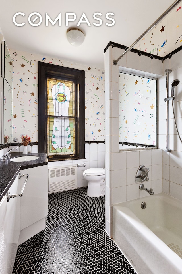 623 2nd St, New York City, NY 11215 - full bathroom featuring wallpapered walls, toilet, vanity, tile patterned floors, and tile walls