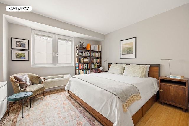 145 Park Pl Unit 5E, New York City, NY 11217 - bedroom with light wood-style flooring and an AC wall unit