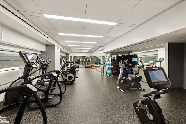 workout area featuring a wall mounted air conditioner