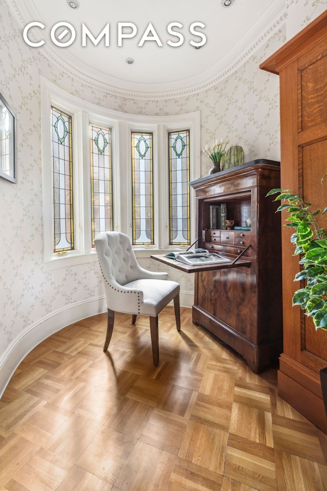 sitting room featuring wallpapered walls and ornamental molding