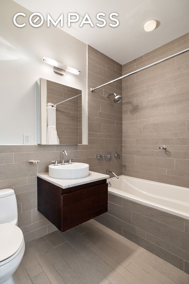 50 W 15th St Unit 7E, New York City, NY 10011 - bathroom with tiled shower / bath combo, vanity, and tile walls