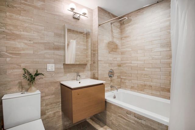 686 Mac Donough St Unit 3A, New York City, NY 11233 - bathroom with tiled shower / bath combo, vanity, toilet, and tile walls