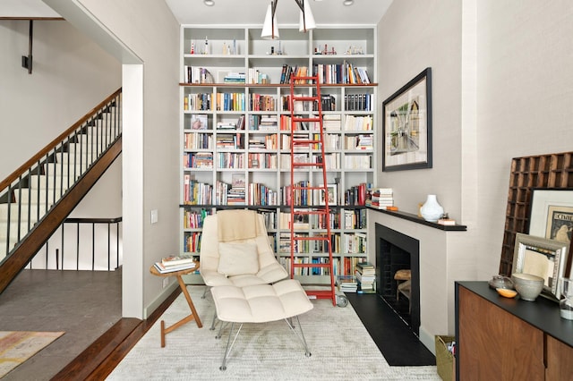 546 E 87th St, New York City, NY 10128 - living area featuring wood finished floors, stairway, a fireplace, and built in features