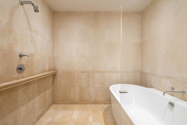 546 E 87th St, New York City, NY 10128 - full bath with a soaking tub, tile walls, and tile patterned flooring