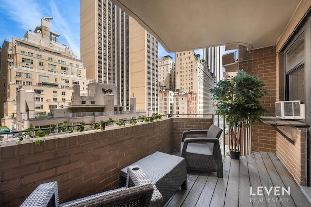 balcony with cooling unit and a view of city