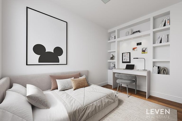 bedroom featuring wood finished floors, baseboards, and a desk