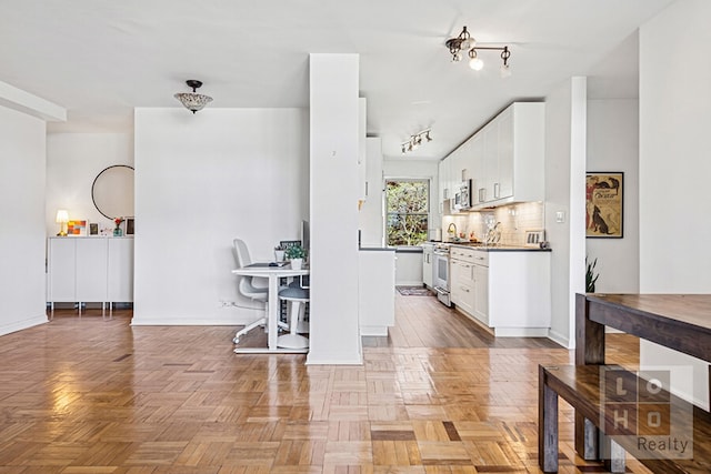455 Fdr Dr Unit B405, New York City, NY 10002 - kitchen featuring white cabinetry, stainless steel appliances, and backsplash