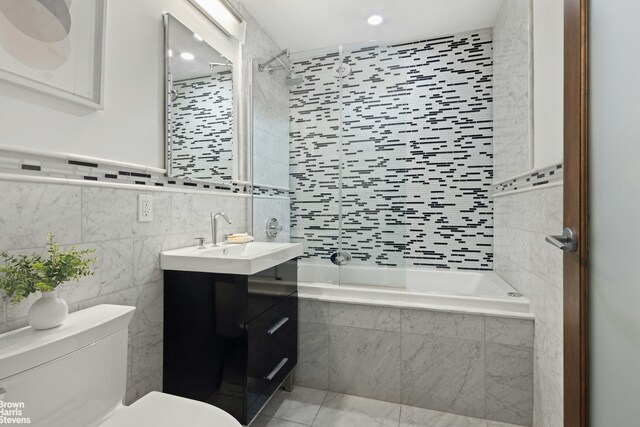 357 Dean St Unit 4A, New York City, NY 11217 - bathroom featuring toilet, tile walls, vanity, tiled shower / bath combo, and recessed lighting