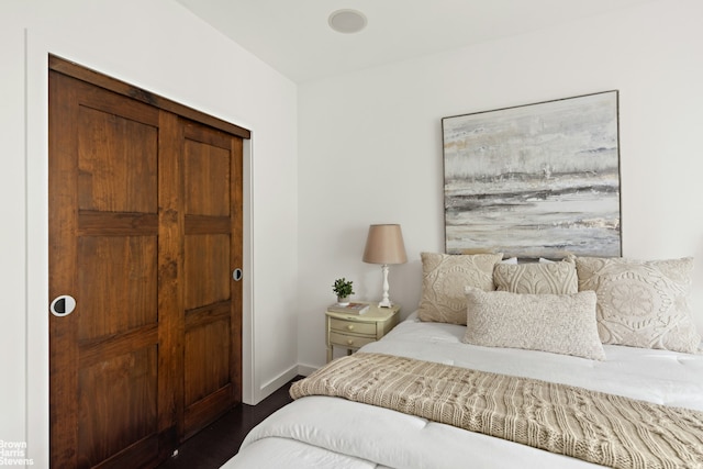 bedroom with baseboards and dark wood-style floors