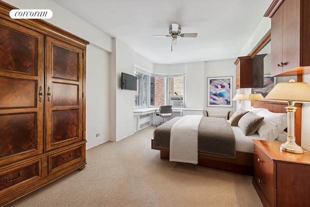 bedroom featuring light colored carpet and a ceiling fan