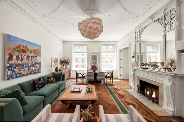 living area with ornamental molding and a high end fireplace