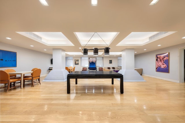 interior space featuring baseboards, light wood-style flooring, and coffered ceiling