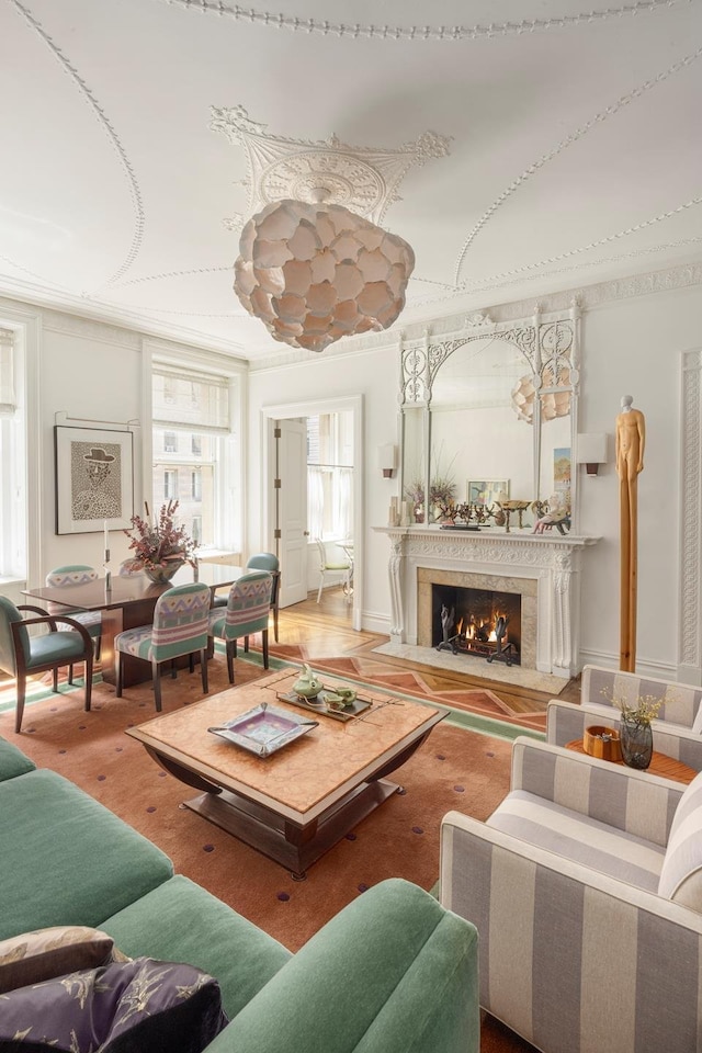 living room featuring a high end fireplace and wood finished floors
