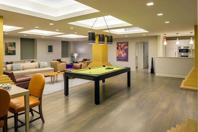 playroom with a skylight, pool table, wood finished floors, a tray ceiling, and recessed lighting