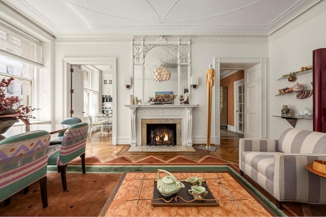 sitting room featuring ornamental molding and a premium fireplace