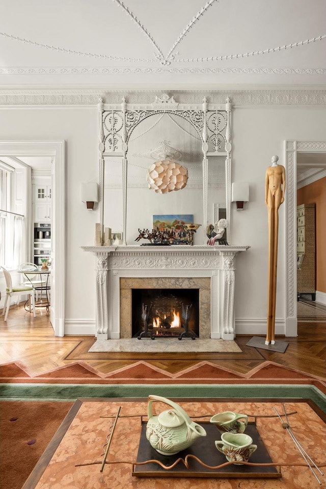 detailed view of baseboards, inlaid floor details, a fireplace, and wood finished floors