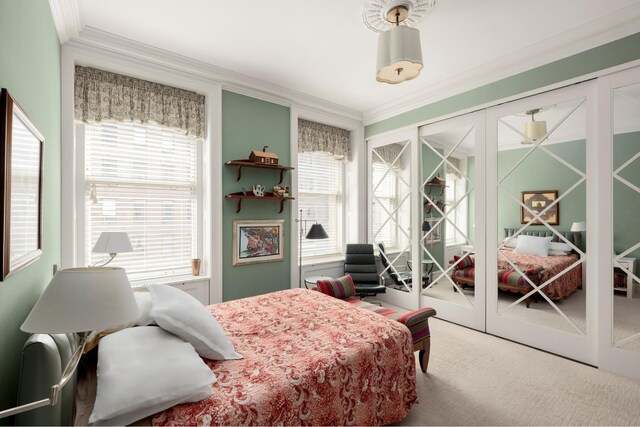 bedroom with ornamental molding and carpet flooring