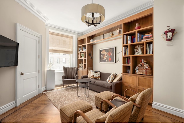 sitting room featuring baseboards, ornamental molding, and a chandelier