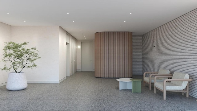 corridor with recessed lighting, dark speckled floor, and baseboards