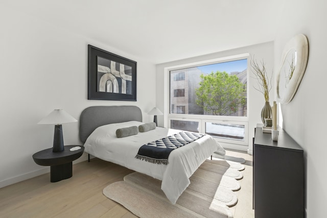 bedroom with wood finished floors and baseboards