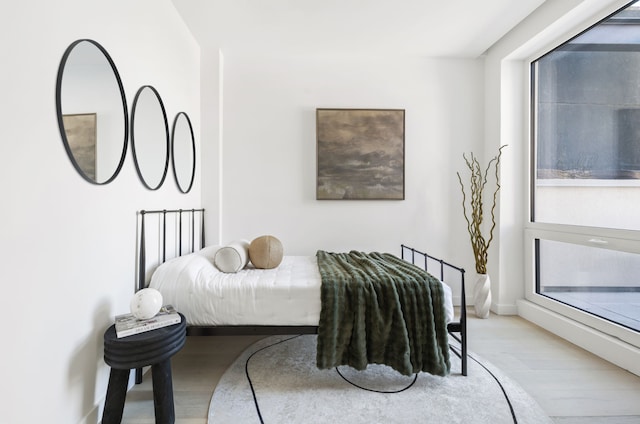 bedroom with wood finished floors and baseboards