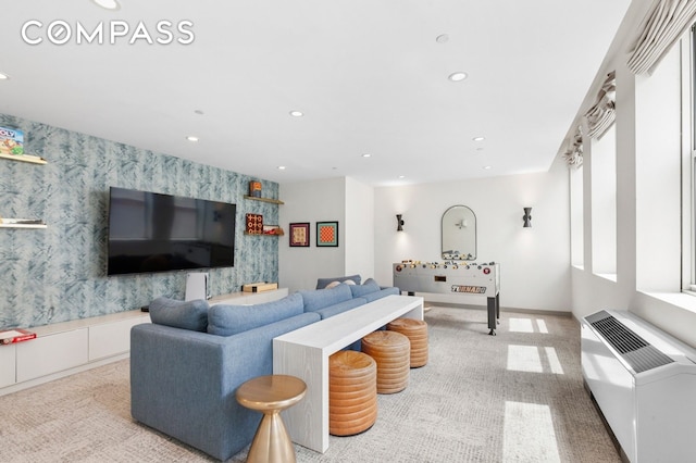 living area with wallpapered walls, recessed lighting, light colored carpet, and an accent wall