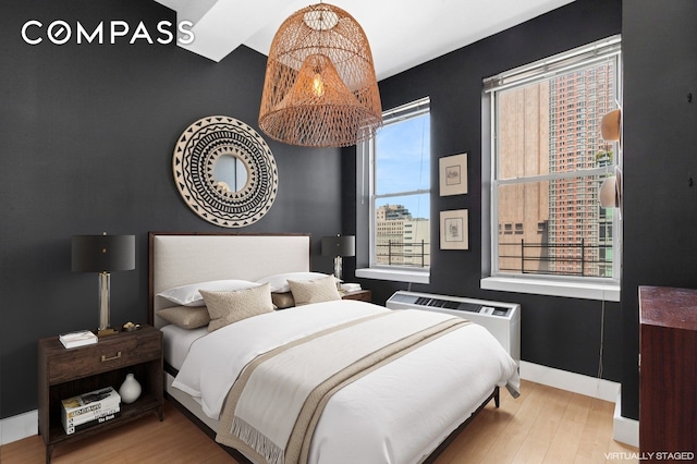 bedroom with wood finished floors and baseboards