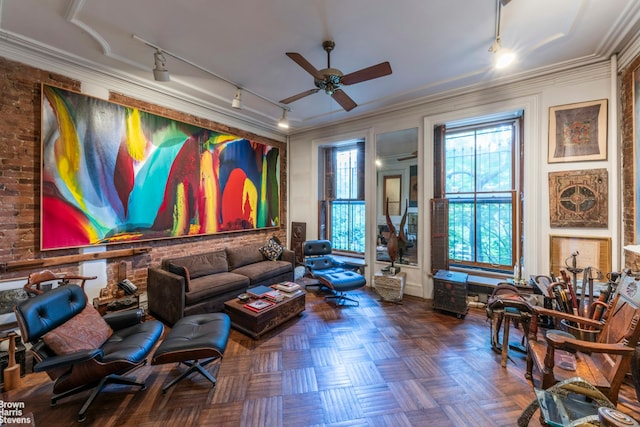 living area featuring track lighting, a ceiling fan, and crown molding
