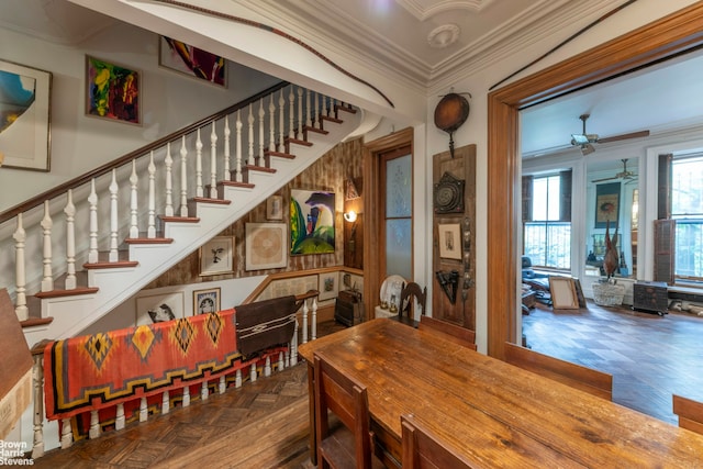 dining room featuring crown molding, stairway, and ceiling fan