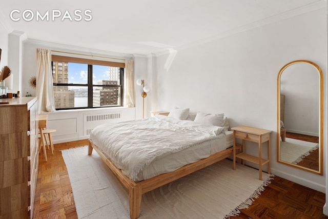 bedroom with radiator and crown molding