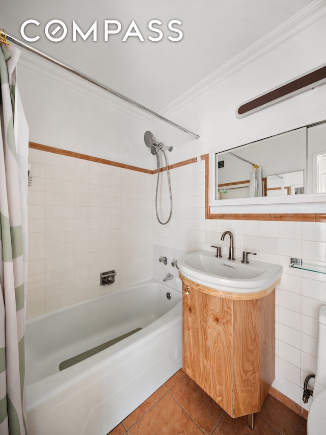 full bath with ornamental molding, tile walls, tile patterned flooring, shower / bathtub combination with curtain, and vanity