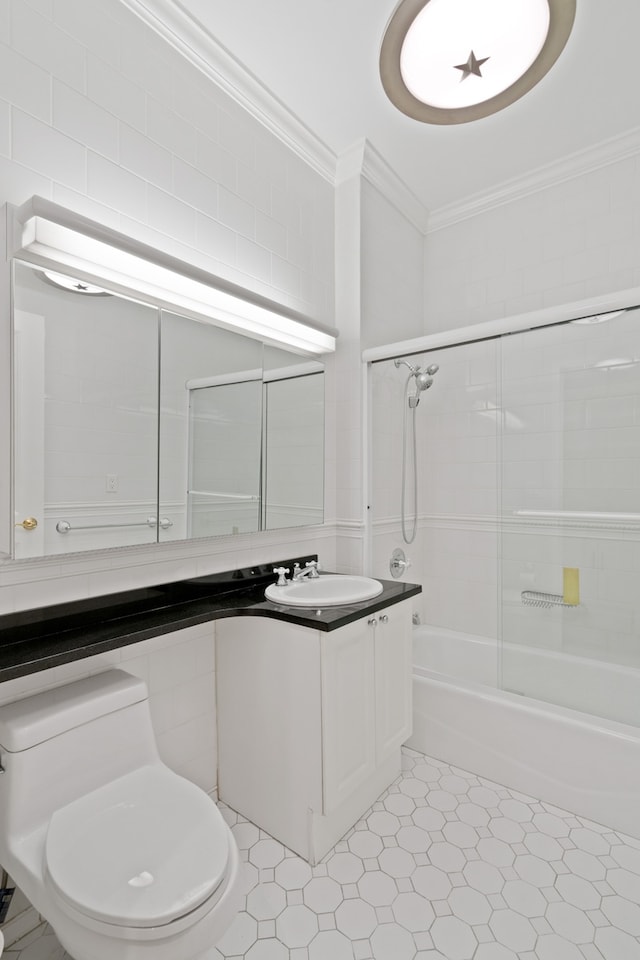350 E 82nd St Unit 7-G, New York City, NY 10028 - bathroom featuring ornamental molding, vanity, combined bath / shower with glass door, and tile patterned floors