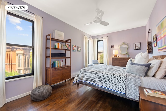 bedroom with wood finished floors, baseboards, and a ceiling fan
