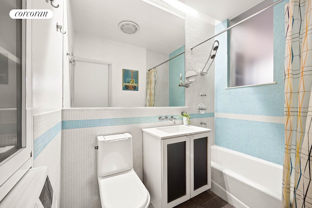bathroom with toilet, shower / bath combination with curtain, and vanity
