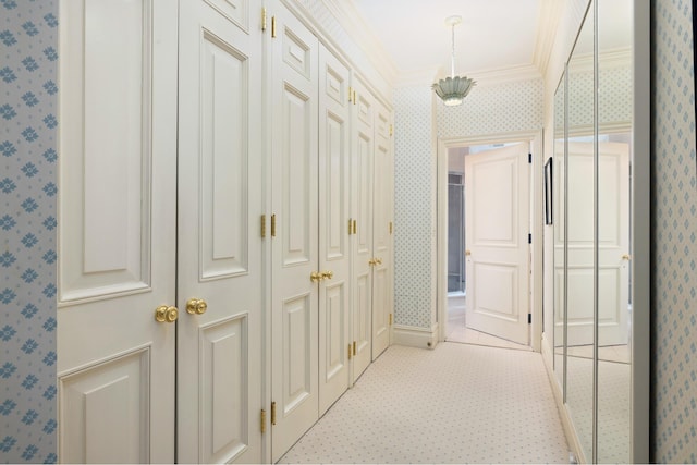 corridor with crown molding, wallpapered walls, and light colored carpet