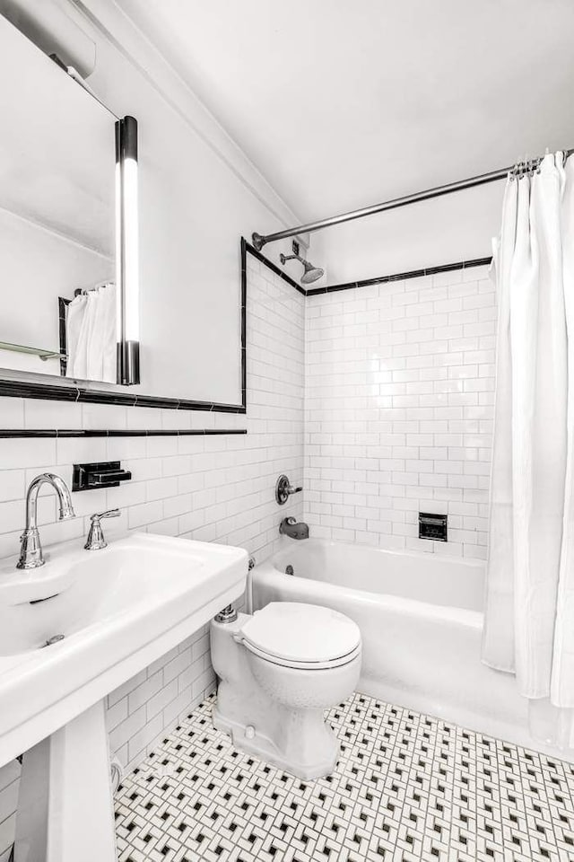 bathroom with toilet, shower / bath combo, tile walls, and ornamental molding