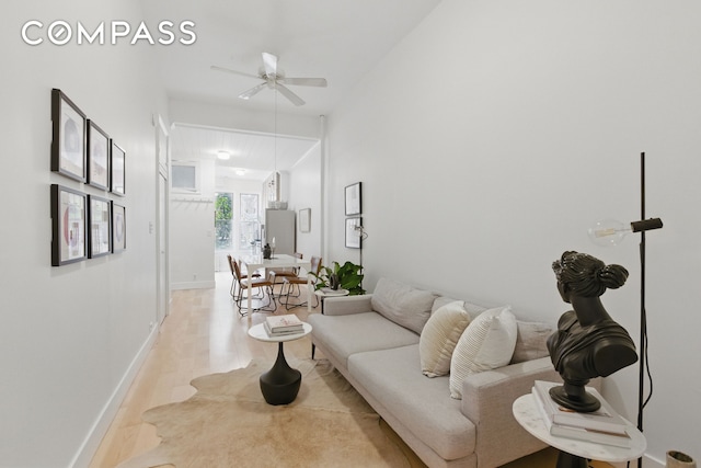 152 N 9th St Unit 1R, New York City, NY 11249 - living area featuring light wood finished floors, ceiling fan, and baseboards