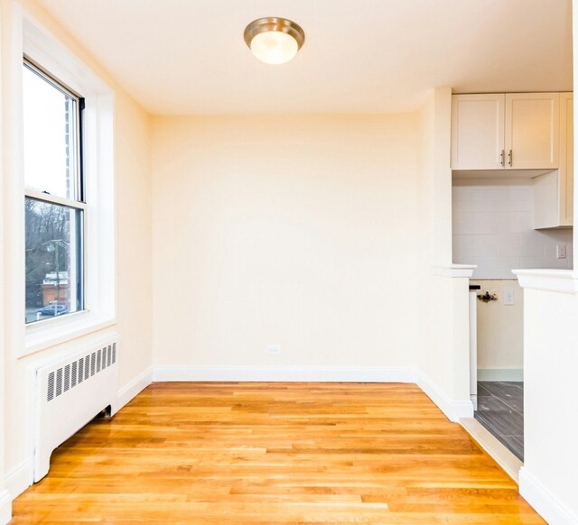 5715 Mosholu Ave Unit 6F, New York City, NY 10471 - unfurnished dining area featuring radiator heating unit, light wood-style floors, and plenty of natural light
