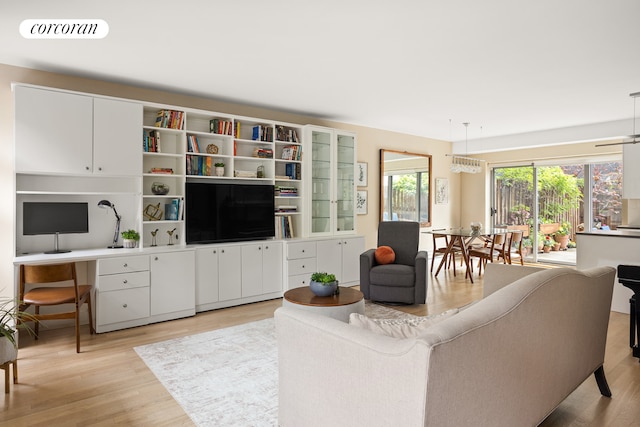 living area featuring light wood-style flooring and a desk