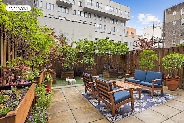 view of patio with an outdoor living space and fence