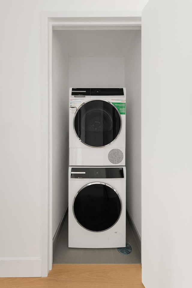 684 Dean St Unit 4, New York City, NY 11238 - washroom with stacked washer / drying machine, tile patterned floors, and baseboards