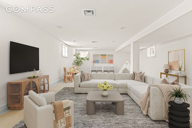 living room featuring baseboards and recessed lighting