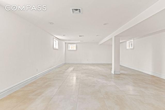 below grade area featuring light tile patterned flooring, baseboards, and recessed lighting