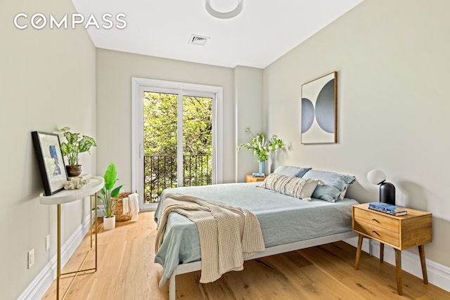 bedroom with baseboards and wood finished floors