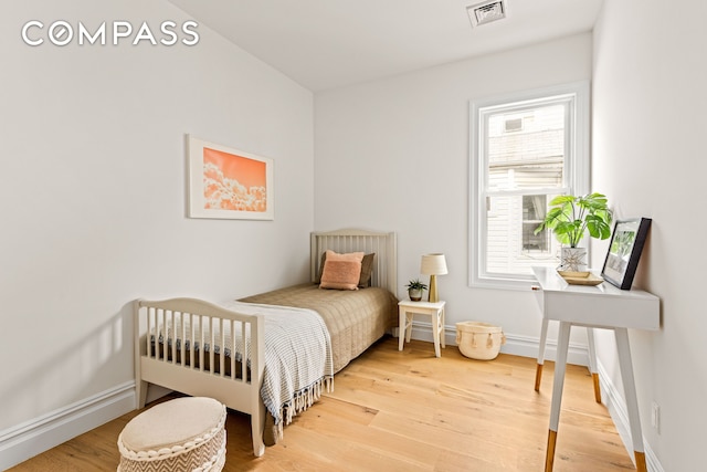 409 E 4th St, New York City, NY 11218 - bedroom featuring light wood-type flooring and baseboards