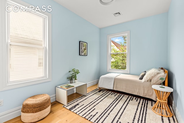 bedroom featuring wood finished floors and baseboards