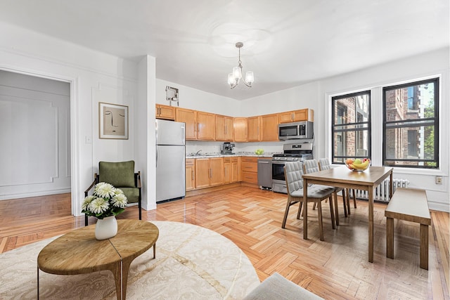 3400 Wayne Ave Unit C51, New York City, NY 10467 - kitchen with appliances with stainless steel finishes, light countertops, a chandelier, and hanging light fixtures
