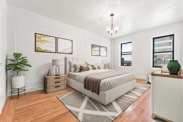 3400 Wayne Ave Unit C51, New York City, NY 10467 - bedroom with radiator heating unit, a chandelier, and light wood-style flooring