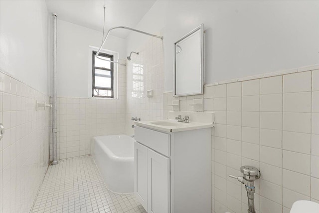 3400 Wayne Ave Unit C51, New York City, NY 10467 - full bath featuring tile walls, vanity, tile patterned floors, wainscoting, and washtub / shower combination